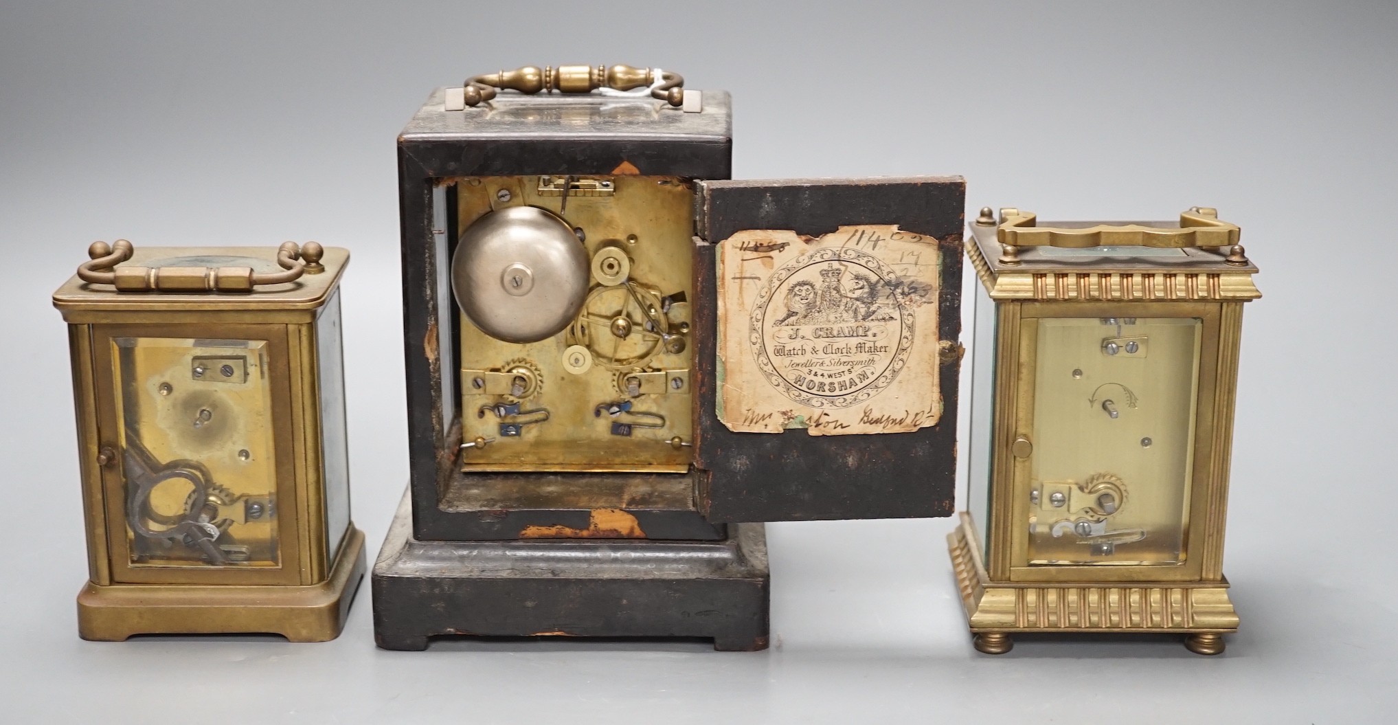 A mid 19th century French ebony veneered carriage clock, 16cm high with J. Cramp Horsham retailers label, a Mappin and Webb carriage clock, another by Mann of Gloucester, tallest 15cms high